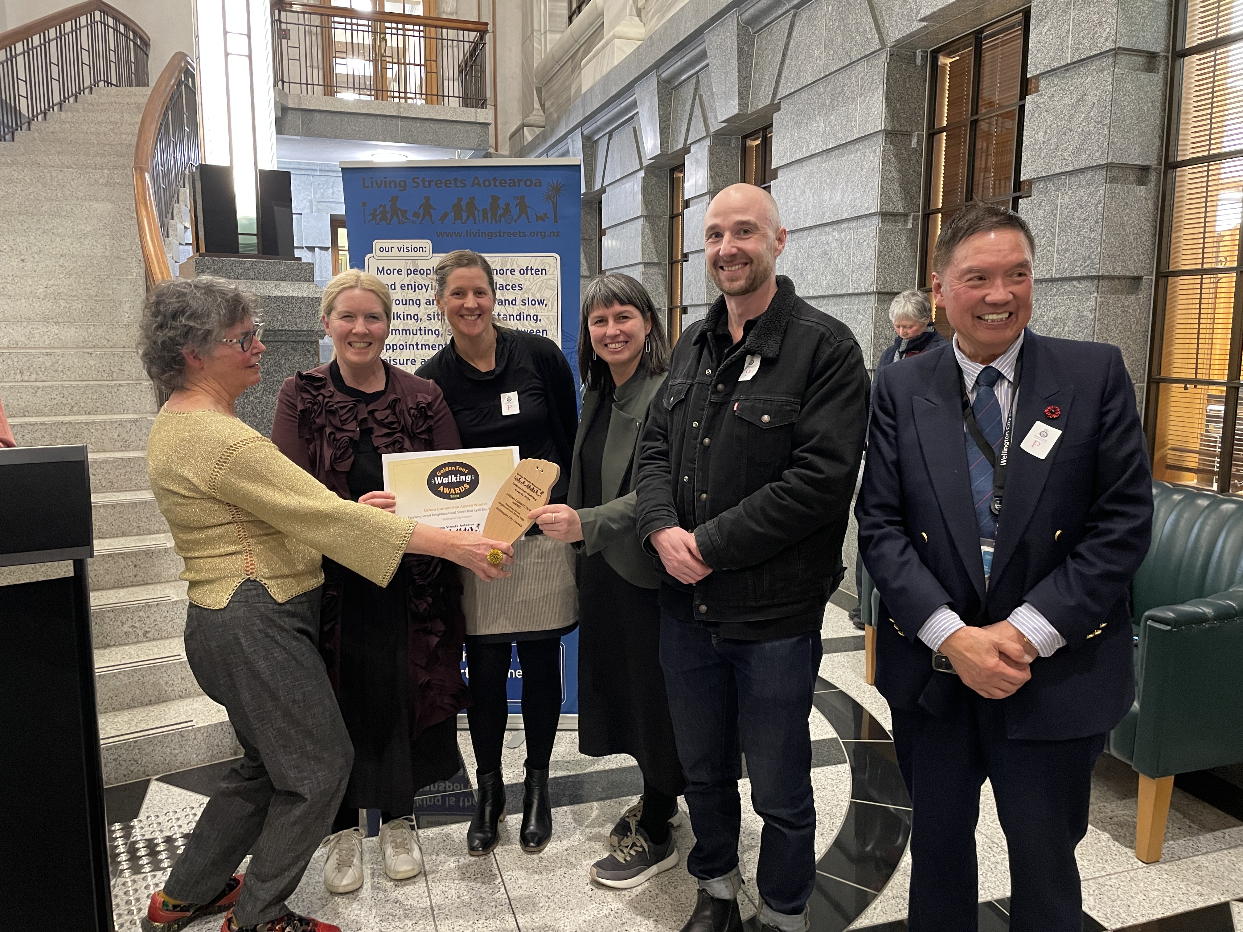 Ellen Blake from Living Streets Aotearoa presenting the award to the Wellington City Council team at the awards evening at Parliament. 